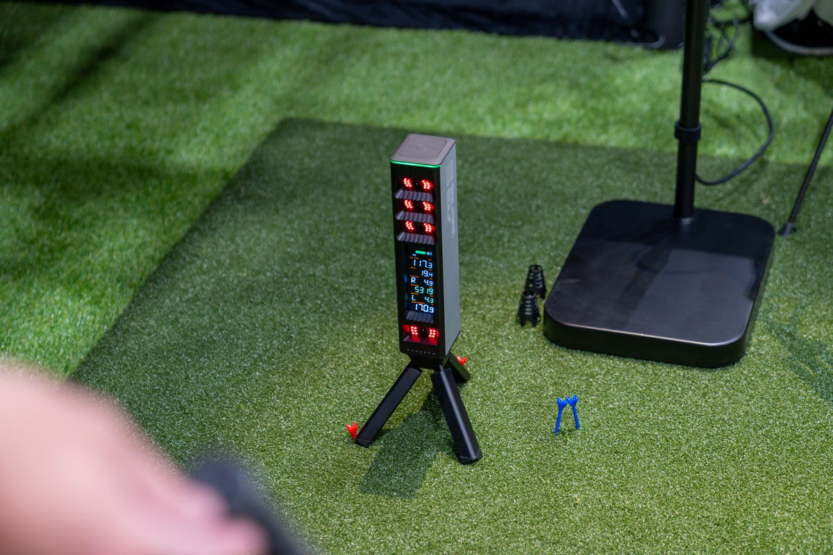 Square Golf Omni floor launch monitor operating on a turf hitting area