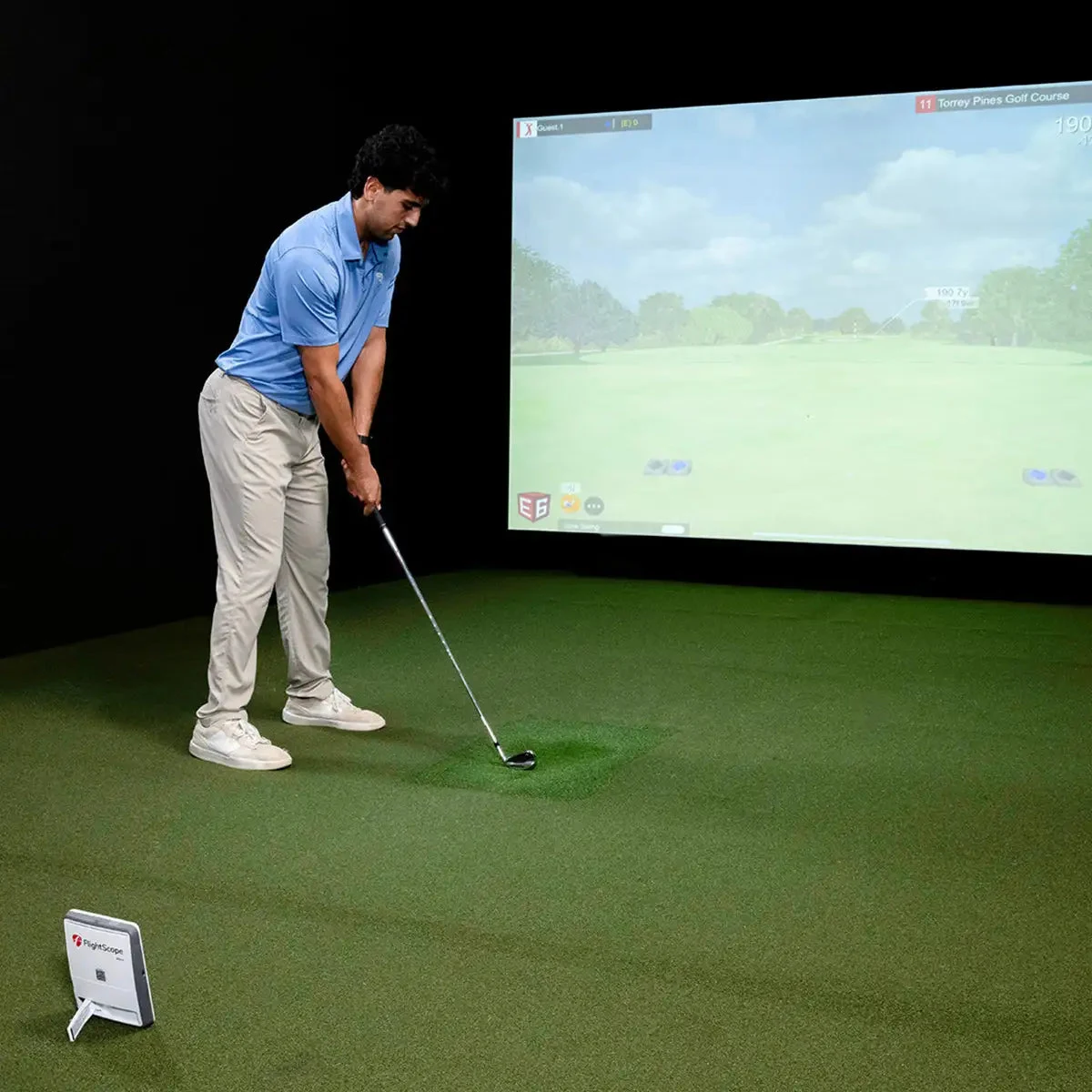 Official photo of a real golfer using FlightScope Mevo Gen2 indoors