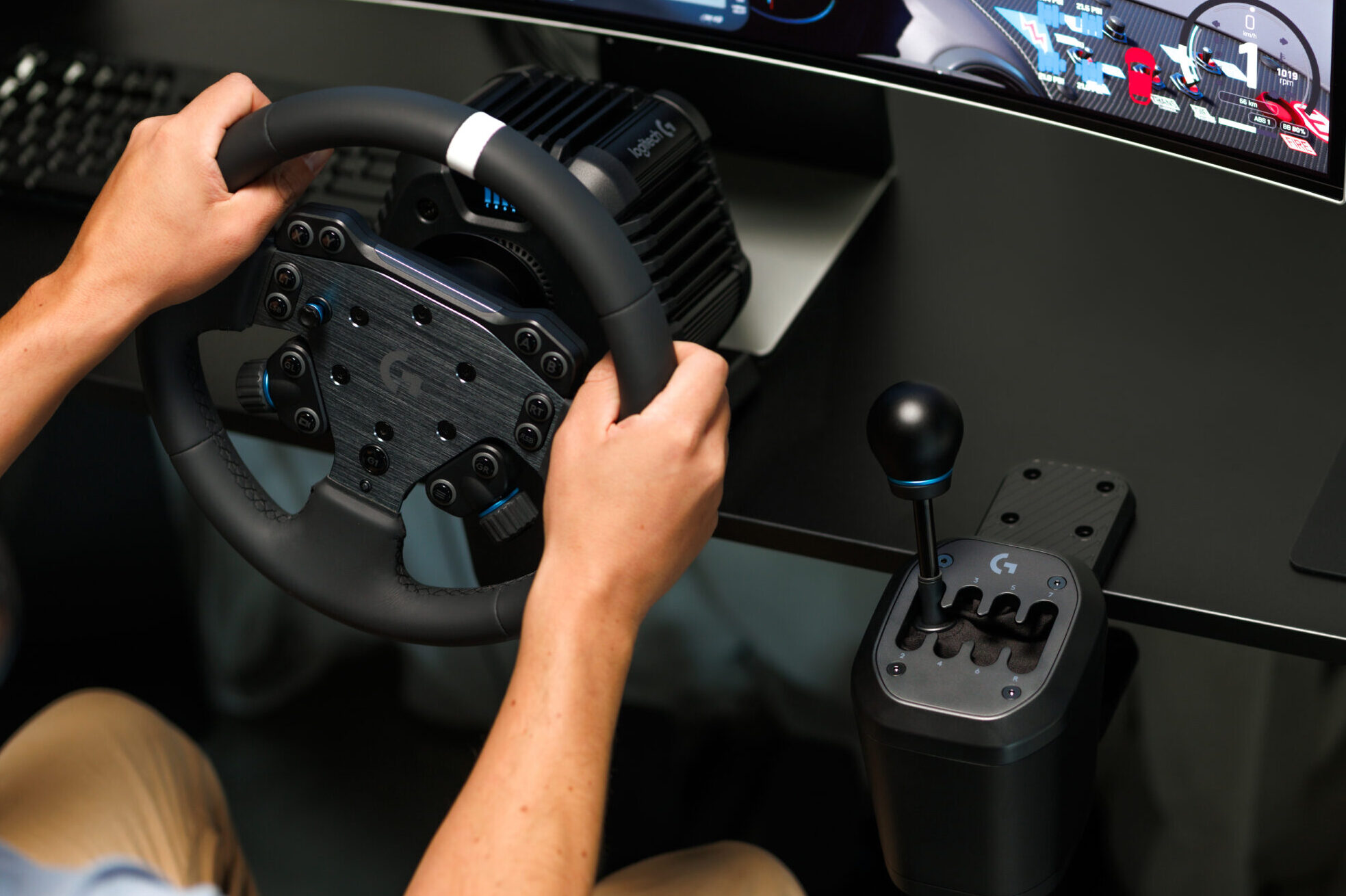 Driver using a Logitech RS50 direct-drive wheel and RS H-shifter at a racing desk