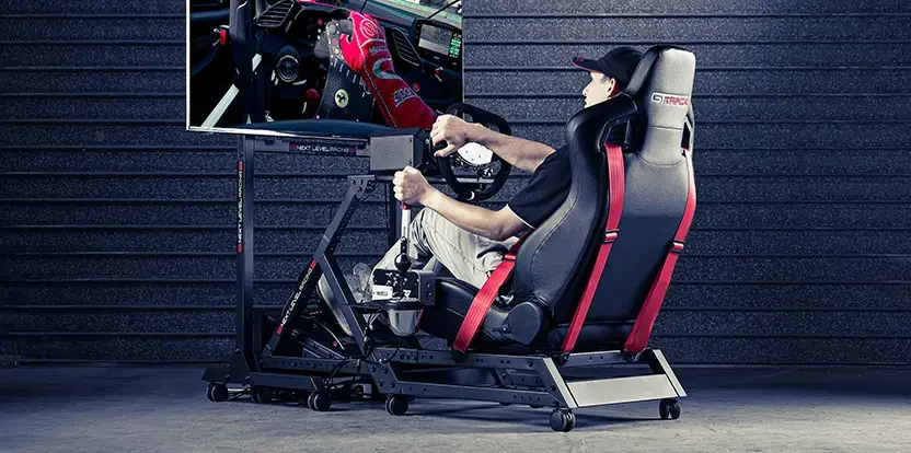 Official real-use marketing photo of a driver seated in the Next Level Racing GTTrack simulator cockpit