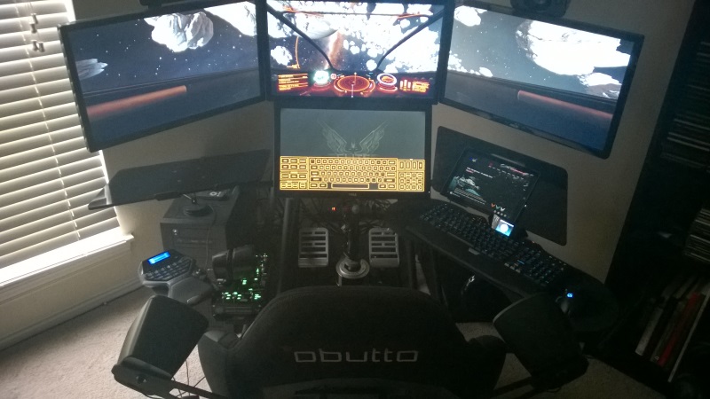 Installed community Elite Dangerous cockpit rig by CMDR Technocrat with triple displays HOTAS pedals and head tracking