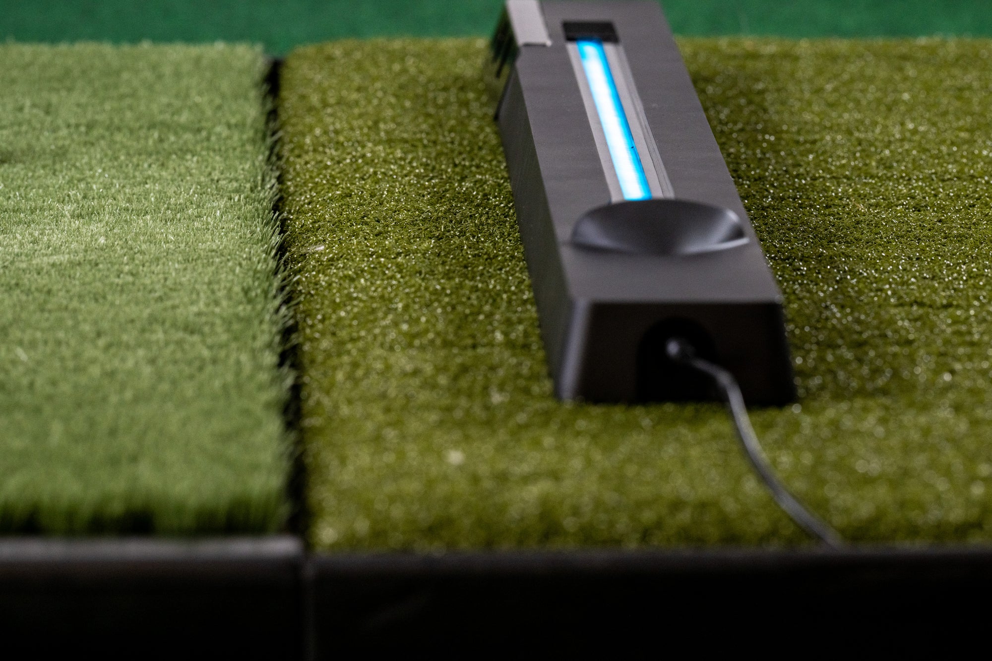 OpenLaunch Nova camera launch monitor on a golf mat