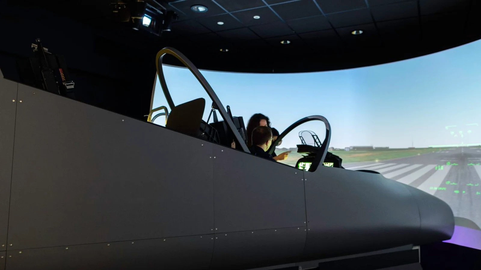 Real pilot using installed flight simulator throttle and cockpit controls
